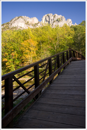 The trail starts off over an arched bridge.