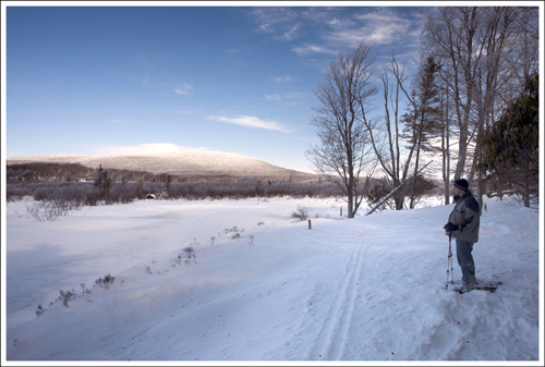 Adam on Snowshoes Adam takes a look over the frozen Blackwater River.